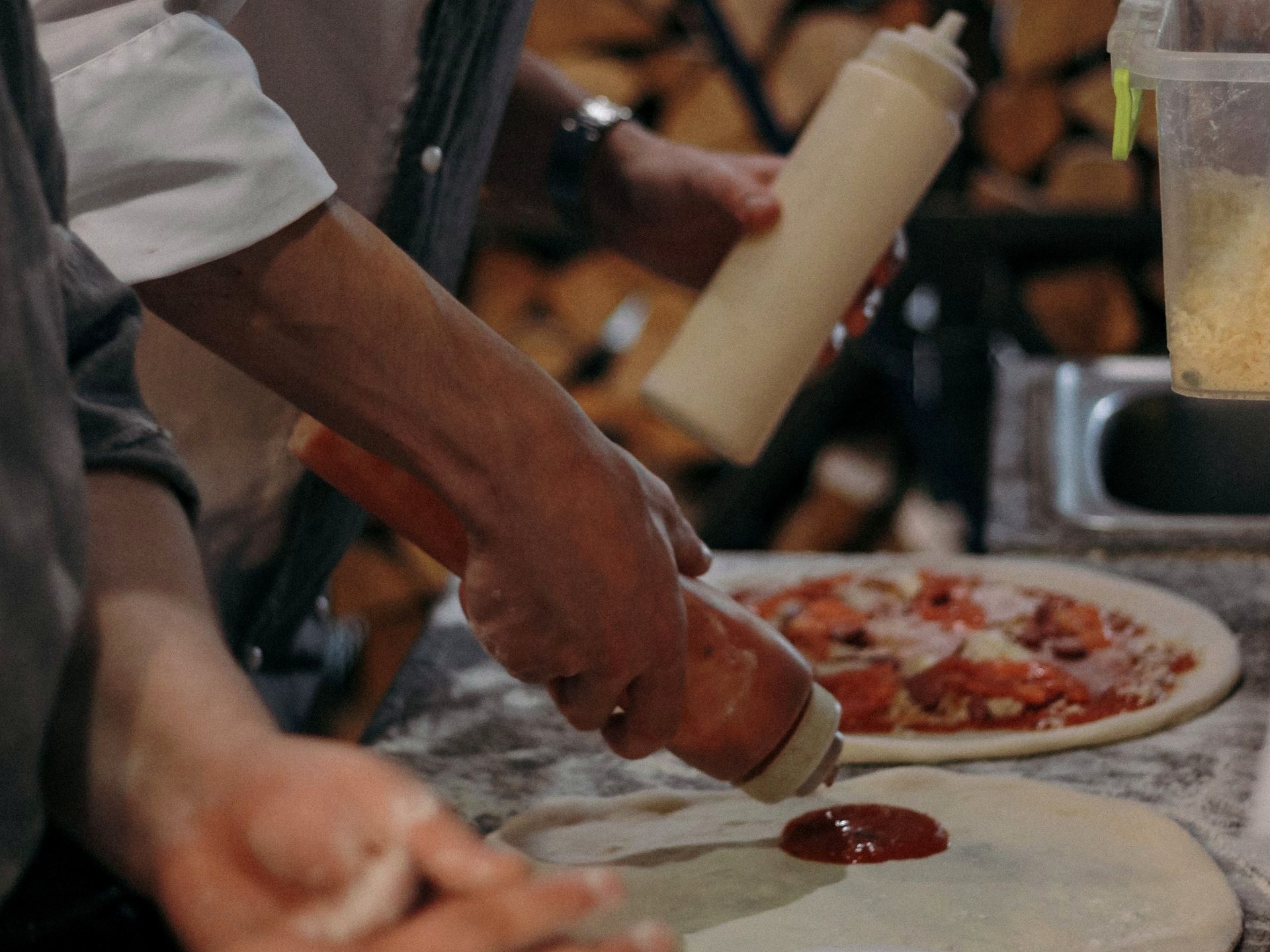 Allergens & Dietary Hands stretching pizza dough