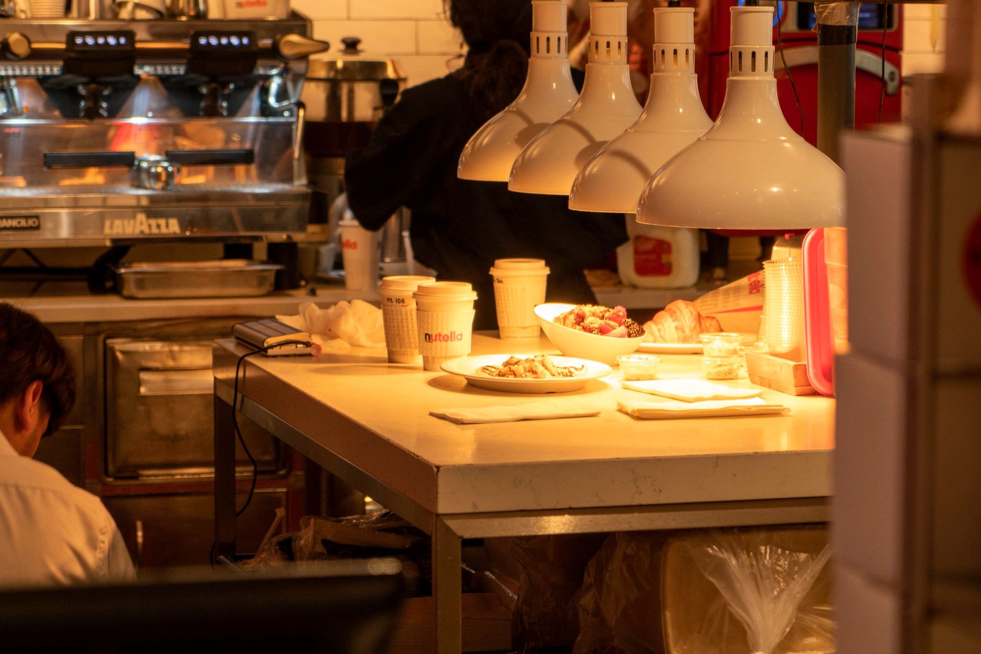 A small open kitchen with a chef at work