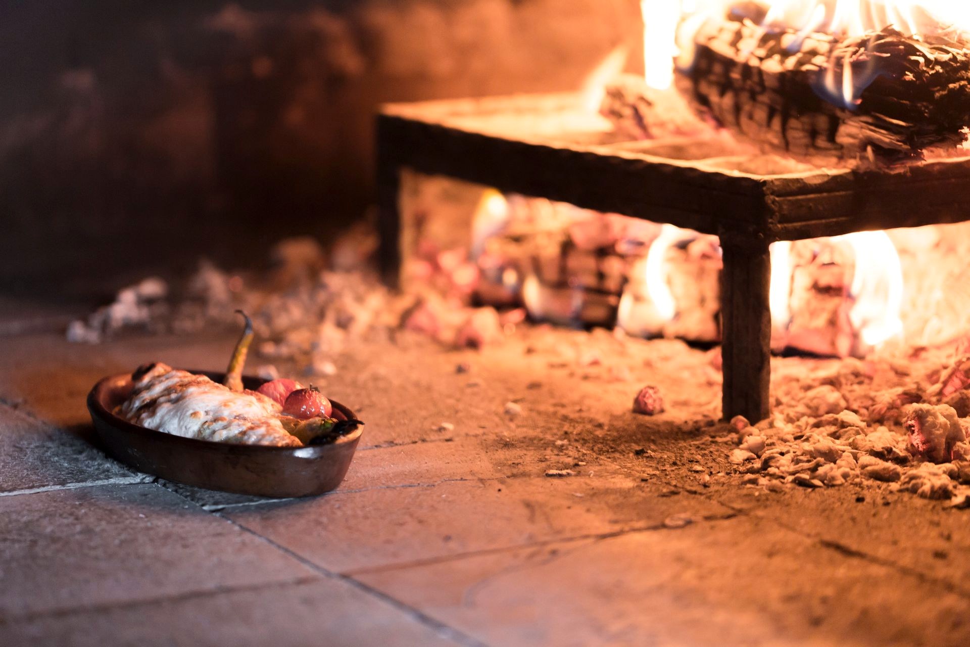 A pan cooking over an open flame