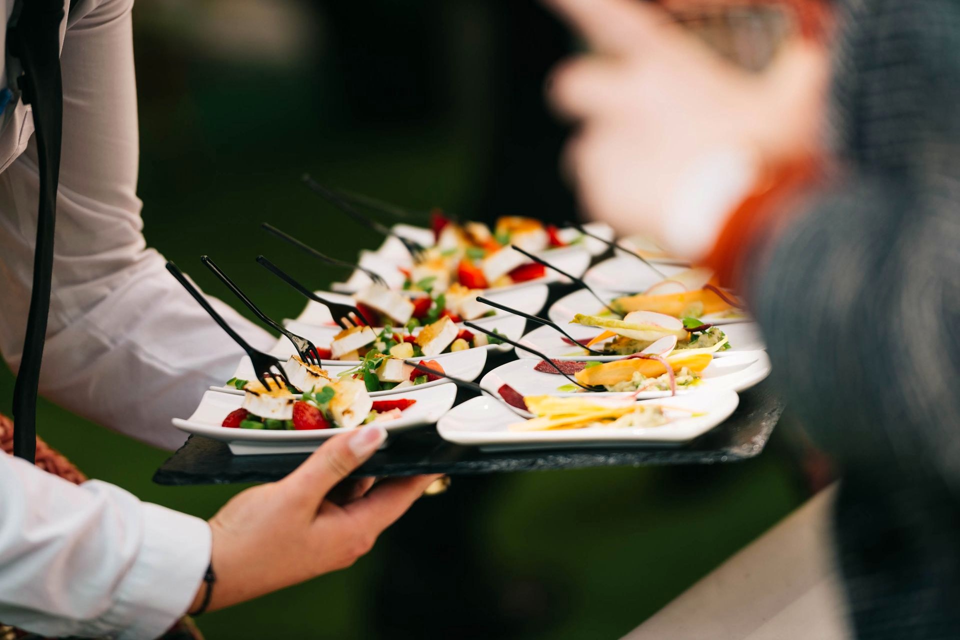 A platter of food being carried to a table