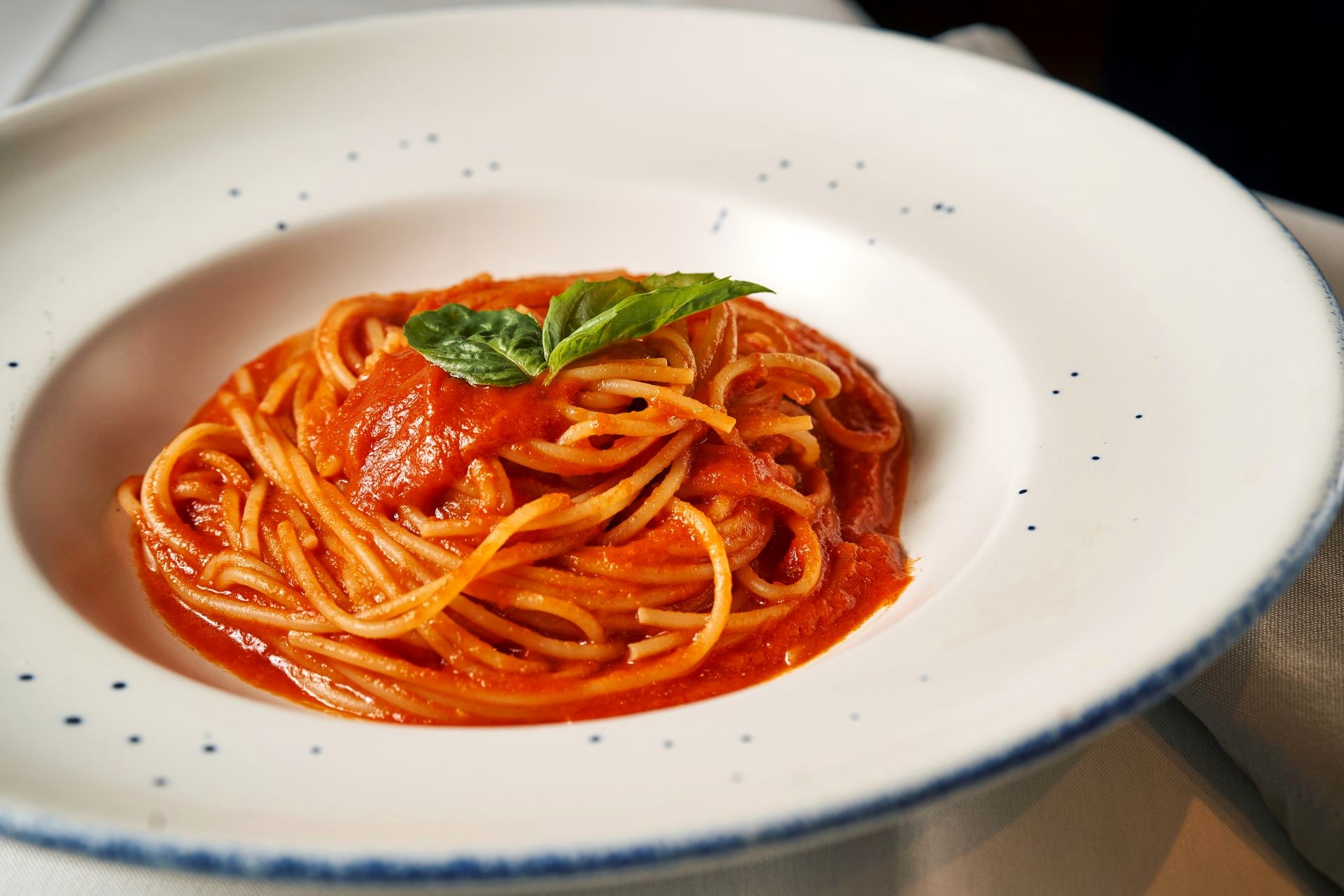Menu — Pasta Spaghetti in tomato sauce on a white plate
