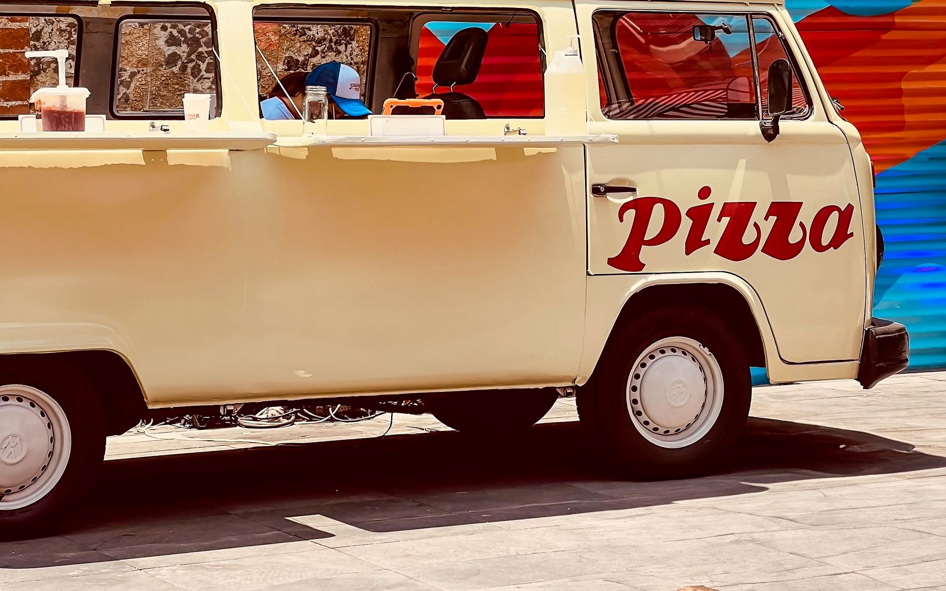 A pizza van with an open serving hatch