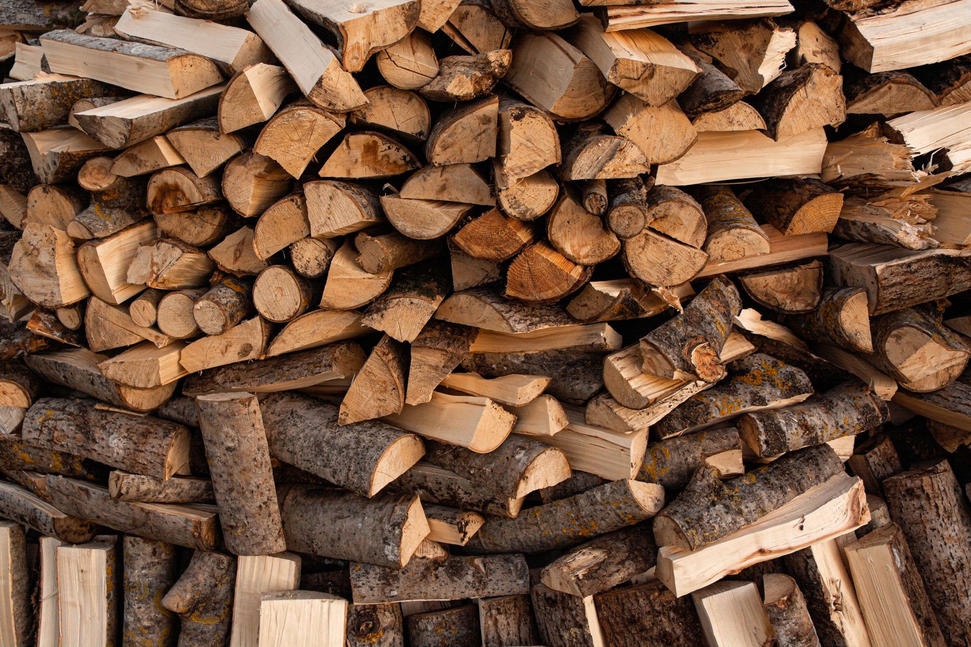 Split firewood stacked by the oven